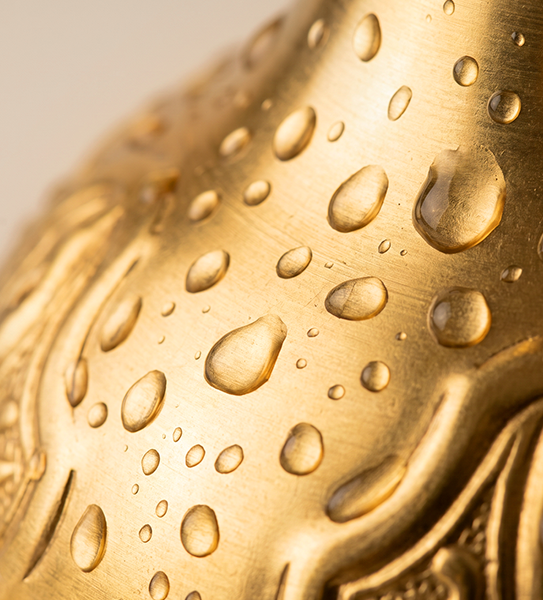 Water droplets on a gold finish